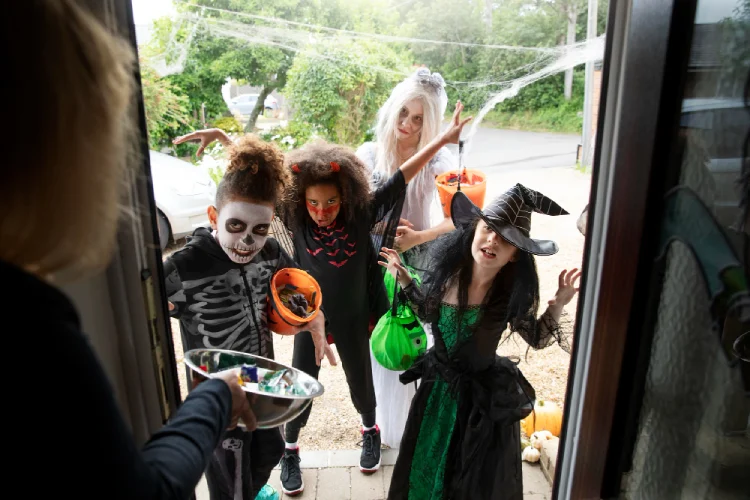 Trick-or-treaters at the door to collect candy